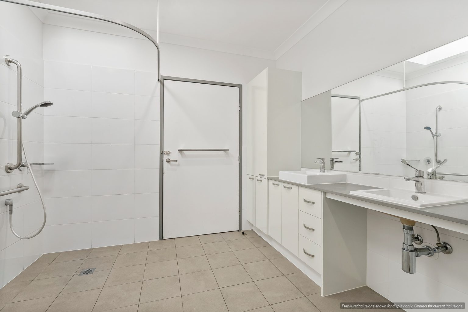 Modern accessible bathroom in Maroubra, Sydney, featuring a walk-in shower, wall-mounted grab bars, floating vanity, large mirror, and tiled floor—perfect for comfortable living in the Eastern Suburbs.