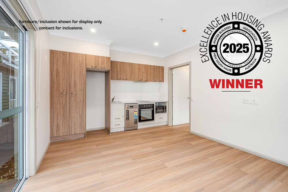 Modern kitchen and living area with wood flooring, built-in appliances, and a large award badge overlay reading "2025 Excellence in Housing Awards Winner" in vibrant Sydney near Parramatta.