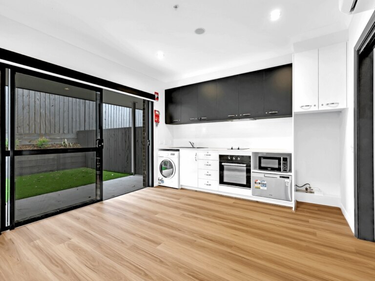 A kitchen in 10B Concord NSW with a sliding door.