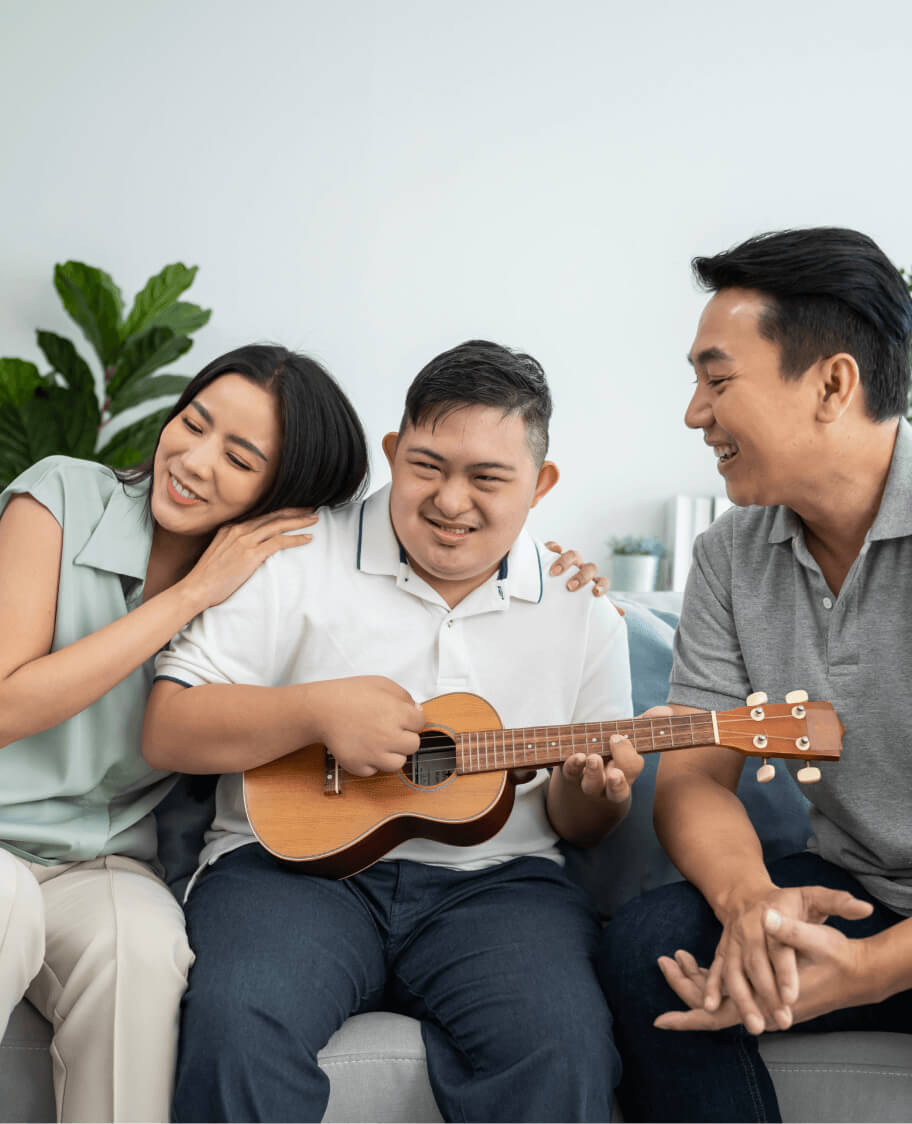 Family playing ukulele at Edenbridge living home