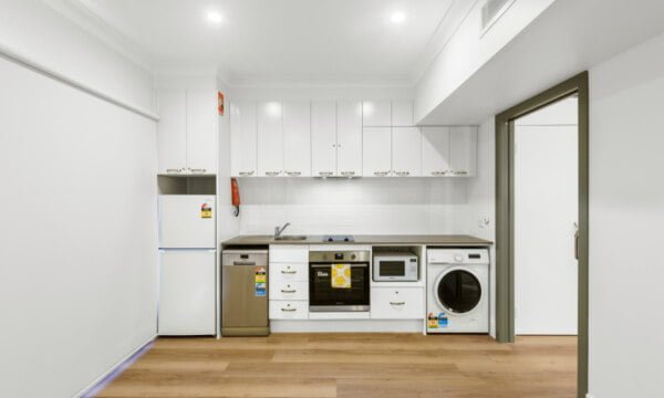 A small kitchen with a washer and dryer.