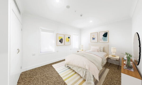 A bedroom with a bed and a bedside table.