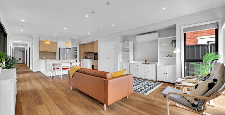 A living room and kitchen with hardwood floors.