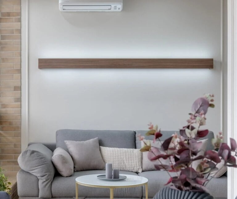 A modern living room with a wall mounted air conditioner.