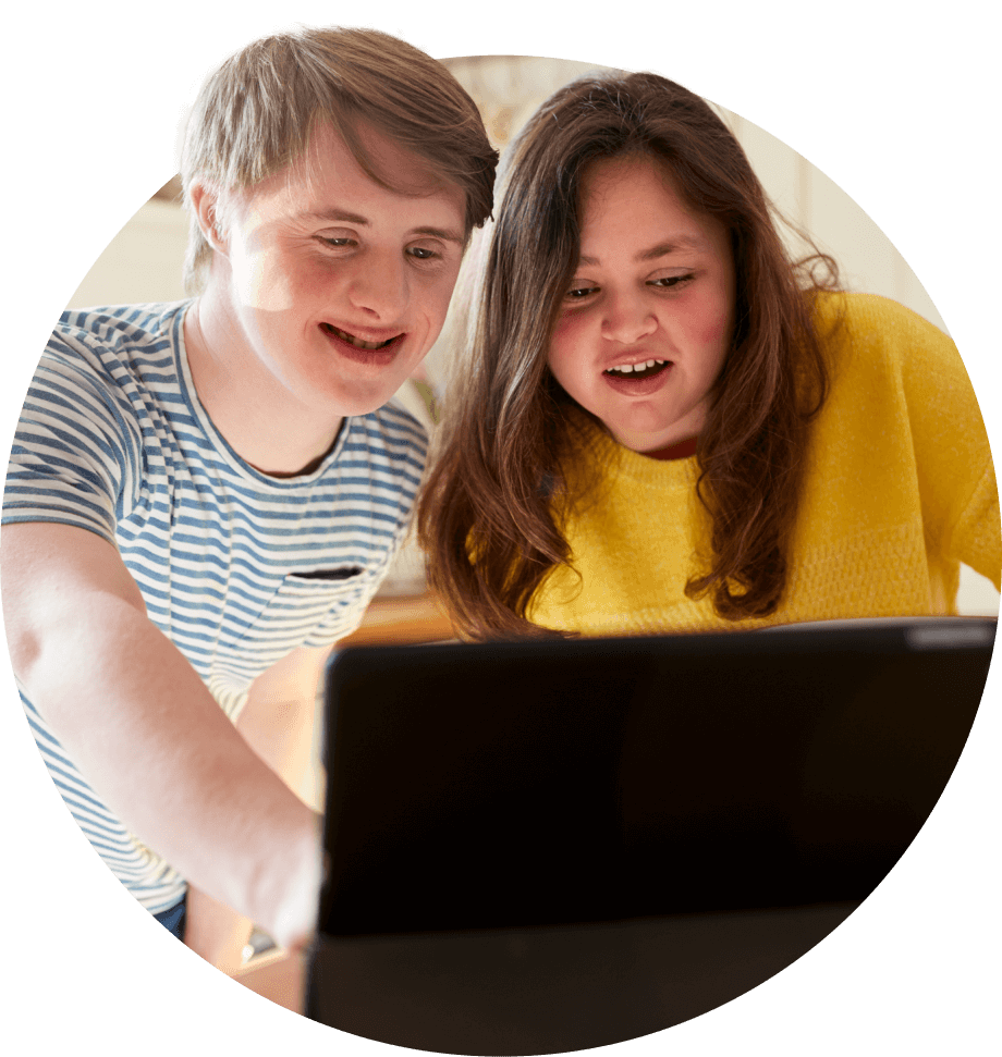 A boy and girl looking at a laptop.