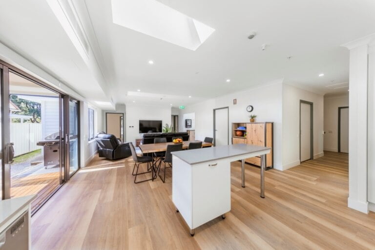 An open plan kitchen and dining area with hardwood floors NSW.