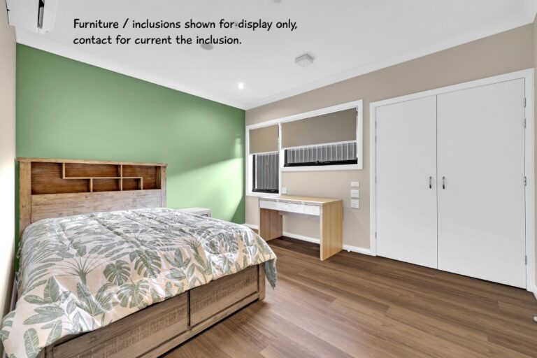 A bedroom in Parramatta with a bed, desk, and green accent wall. The room features a double-door closet and wooden flooring. Text on the image mentions that furniture is for display only and to contact for current inclusion.