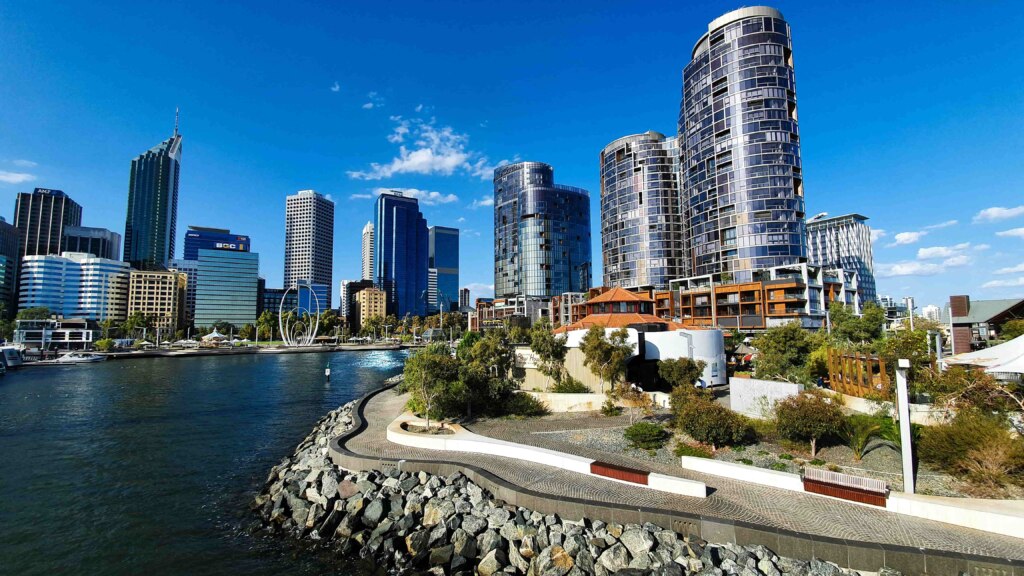 A city with tall buildings and a river in the background, offering accessible accommodations.