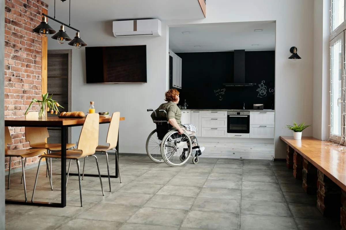 Accessible modern home with open-plan dining and kitchen area showing wheelchair-friendly SDA housing design